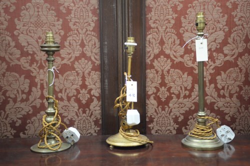 Lot 48 - Three early 20th Century brass table lamps,...