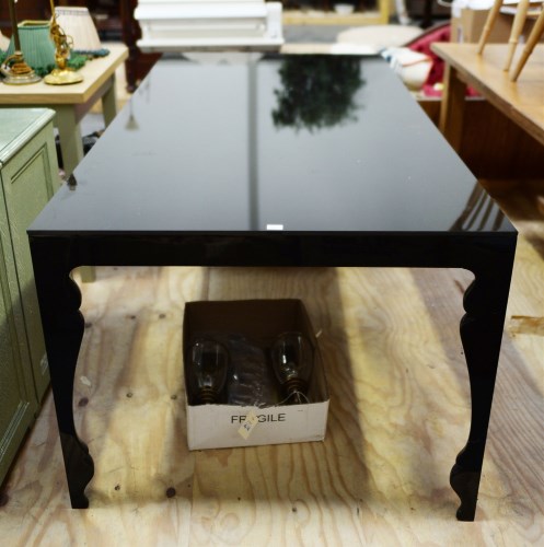 Lot 104 - A rectangular black dining table with black...
