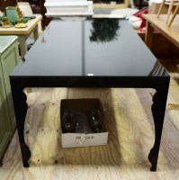 Lot 104 - A rectangular black dining table with black...