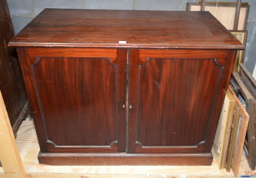Lot 125 - A Georgian mahogany cupboard with two panel...