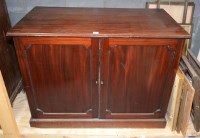 Lot 125 - A Georgian mahogany cupboard with two panel...