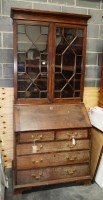 Lot 156 - A Georgian oak bureau bookcase, the flared...