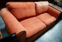 Lot 297 - A large three seater sofa with loose seat and...