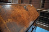 Lot 330 - A George I walnut bureau cabinet, the top with...