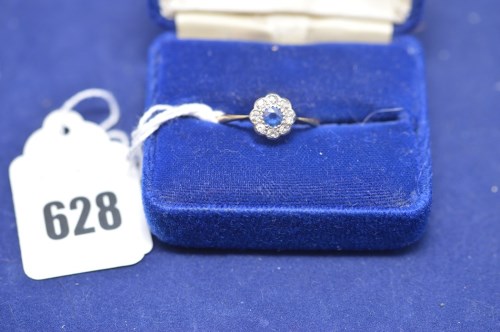 Lot 628 - A sapphire and diamond flowerhead ring on...