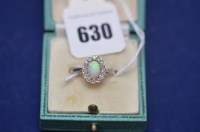 Lot 630 - An opal and diamond cluster ring on yellow...