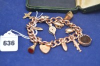 Lot 636 - A 9ct. yellow gold chain linked charm bracelet...