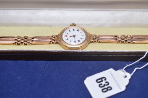 Lot 638 - A 9ct. yellow gold wristwatch with white...