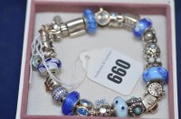 Lot 660 - A silver Pandora charm bracelet with 25 charms,...