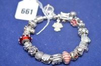 Lot 661 - A silver Pandora charm bracelet with 21 charms,...
