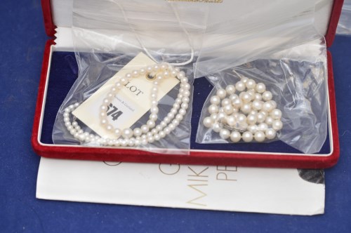 Lot 674 - Two cultured pearl necklaces by Mikimoto, in...