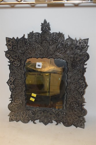 Lot 705 - An Indian white metal mirror, with relief...