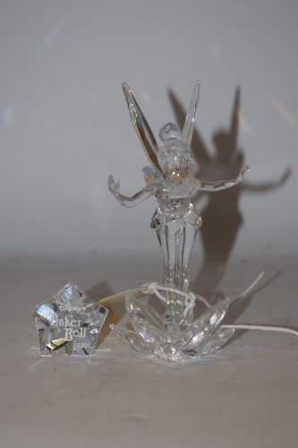 Lot 707 - A Swarovski Tinkerbell and star crystal figurine.