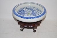 Lot 911 - Chinese shallow dragon bowl on a wooden stand...