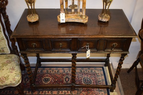 Lot 1133 - A reproduction oak hall table, raised on...