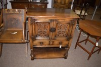 Lot 1215 - A reproduction oak side cabinet with carved...