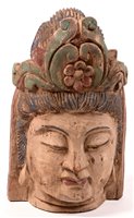 Lot 247 - A carved and polychrome decorated head of Buddha, 40cms high.