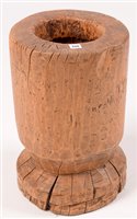 Lot 258 - A Far Eastern rice pounder, mortar, 44cms high.