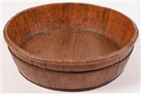 Lot 252 - A large circular coopered wooden barrel bowl, Far Eastern, 63cms diameter.