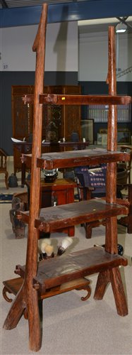 Lot 232 - A set of Indonesian hardwood rustic shelves of...