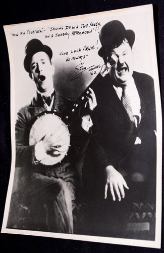 Lot 128 - Stan Laurel; a signed black and white...