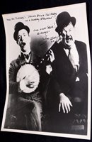 Lot 128 - Stan Laurel; a signed black and white...