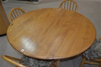 Lot 1072 - Ercol: a light elm and beechwood drop leaf table; and six chairs.
