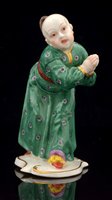 Lot 179 - A Nymphenburg porcelain figure of a Chinese attendant figure