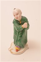 Lot 179 - A Nymphenburg porcelain figure of a Chinese attendant figure