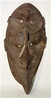 Lot 277A - A carved wood Fijian janus mask with inlaid cowrie shell eyes, 4cms high.