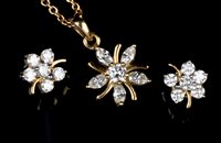 Lot 736 - A diamond pendant and matching earrings, the...