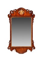 Lot 1012 - A Georgian mahogany parcel gilt wall mirror.