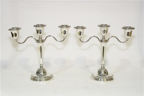 Lot 558 - A pair of silver two-branch candelabra