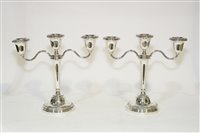Lot 558 - A pair of silver two-branch candelabra