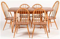 Lot 1146 - An Ercol extending dining table, four Windsor style dining chairs; and two Quaker style armchairs.