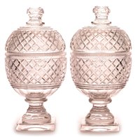 Lot 186 - A pair of cut glass ovoid jars and covers.