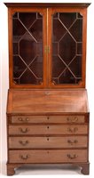 Lot 973 - A mahogany bureau bookcase.