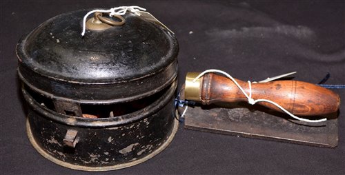 Lot 209 - A Victorian bread rasp, with turned wooden handle; together with a 19th Century tole ware nutmeg jar, with central grater.