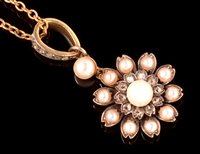 Lot 796 - A diamond and pearl flower pendant