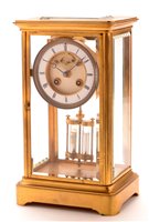 Lot 932 - A late 19th Century French brass four glass mantel clock.