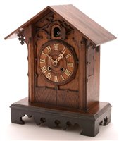 Lot 939 - Gordian Hettich Sohn: a late 19th Century Black Forest carved oak mantel cuckoo clock