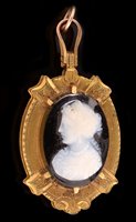 Lot 834 - A Victorian carved hardstone cameo and banded agate locket pendant