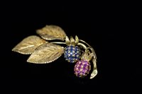 Lot 771 - Sapphire and ruby flower brooch