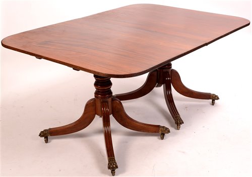 Lot 699 - A twin pedestal D-end dining table.