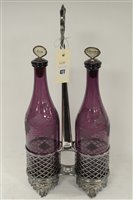 Lot 477 - A pair of amethyst glass decanters