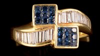 Lot 576 - Sapphire and diamond crossover ring