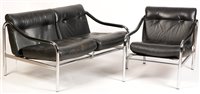 Lot 1115 - Tim Bates for Pieff: a black leather two-seater sofa and matching armchair.