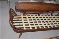 Lot 1089 - Ercol: a stained beech and elm studio couch.