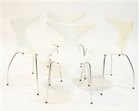 Lot 1150 - Four Dan Form Dolphin Chairs, in white vinyl covers.
