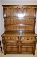 Lot 715 - A reproduction oak dresser.